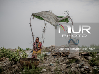 A female scavenger is taking rest under a temporary shed. Dhapa, Kolkata, India. September 10, 2015. *** Go to http://nurphoto.com/en/report...