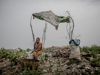 A female scavenger is taking rest under a temporary shed. Dhapa, Kolkata, India. September 10, 2015. *** Go to http://nurphoto.com/en/report...