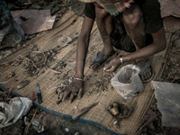 A scavenger is sorting out the metal wastes. Dhapa, Kolkata, India. January 20, 2015. *** Go to http://nurphoto.com/en/reportages/51696 to s...