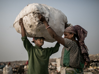 Scavengers are carrying waste. Dhapa, Kolkata, India. January 20, 2015. *** Go to http://nurphoto.com/en/reportages/51696 to see more **** (