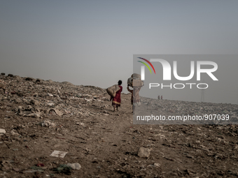 scavengers are returning from the waste dumoing ground, Dhapa, Kolkata, India. January 20, 2015. *** Go to http://nurphoto.com/en/reportages...