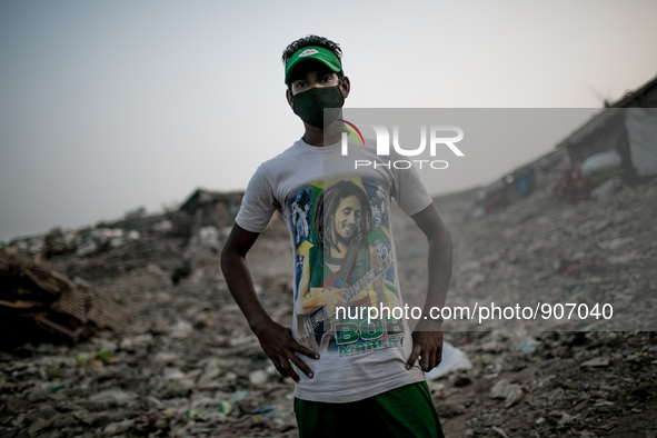 A local young man is posing at the waste dumping ground, Dhapa, Kolkata, India. January 20, 2015. *** Go to http://nurphoto.com/en/reportage...