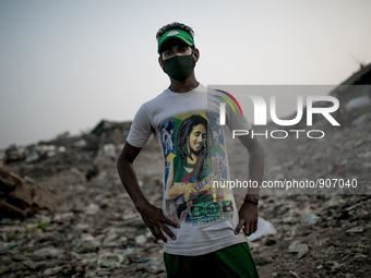 A local young man is posing at the waste dumping ground, Dhapa, Kolkata, India. January 20, 2015. *** Go to http://nurphoto.com/en/reportage...