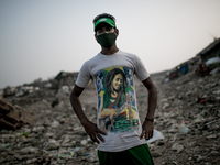 A local young man is posing at the waste dumping ground, Dhapa, Kolkata, India. January 20, 2015. *** Go to http://nurphoto.com/en/reportage...