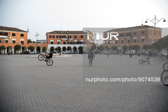 Some teenagers perform bicycle stunts in the monumental Piazza della Repubblica, formerly Piazza della Rivoluzione, built in a characteristi...