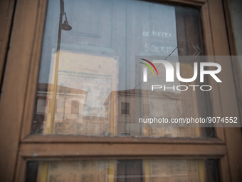 Some buildings reflected in the old window of an abandoned building along Viale Roma, one of the main streets of Tresigallo, in the province...