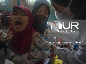 An officer injects a vaccine to a student on child immunization at SD Inpres Palupi, Palu City, Central Sulawesi Province, Indonesia on Octo...