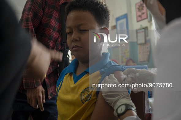 An officer injects a vaccine to a student on child immunization at SD Inpres Palupi, Palu City, Central Sulawesi Province, Indonesia on Octo...