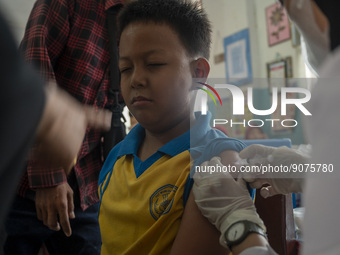 An officer injects a vaccine to a student on child immunization at SD Inpres Palupi, Palu City, Central Sulawesi Province, Indonesia on Octo...