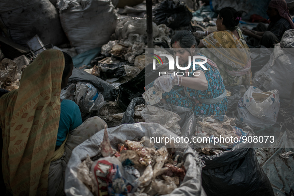 Women are sorting out the plastic bags at Dhapa waste dumping ground, Kolkata, India. January 17, 2015.  *** Go to http://nurphoto.com/en/re...