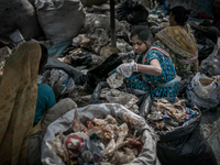 Women are sorting out the plastic bags at Dhapa waste dumping ground, Kolkata, India. January 17, 2015.  *** Go to http://nurphoto.com/en/re...