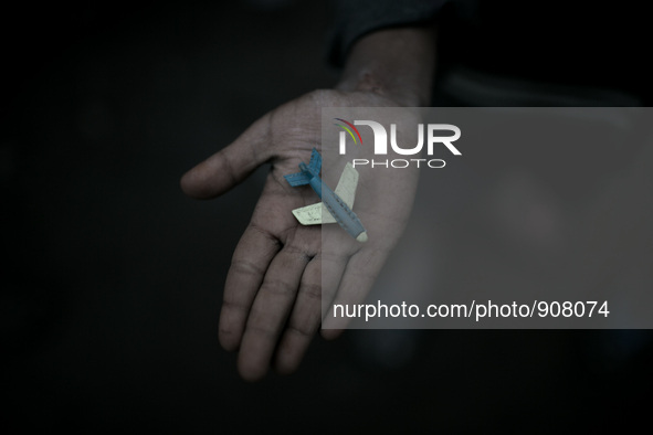 A kid has found a toy plane in the waste dumping ground. Dhapa, Kolkata, India. January 20, 2015.  *** Go to http://nurphoto.com/en/reportag...