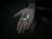 A kid has found a toy plane in the waste dumping ground. Dhapa, Kolkata, India. January 20, 2015.  *** Go to http://nurphoto.com/en/reportag...