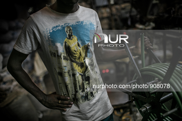 A worker at a plastic pipe factory at Dhapa, Kolkata, India. January 17, 2015.  *** Go to http://nurphoto.com/en/reportages/51754 to see mor...