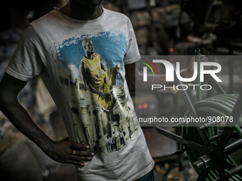 A worker at a plastic pipe factory at Dhapa, Kolkata, India. January 17, 2015.  *** Go to http://nurphoto.com/en/reportages/51754 to see mor...