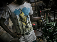 A worker at a plastic pipe factory at Dhapa, Kolkata, India. January 17, 2015.  *** Go to http://nurphoto.com/en/reportages/51754 to see mor...