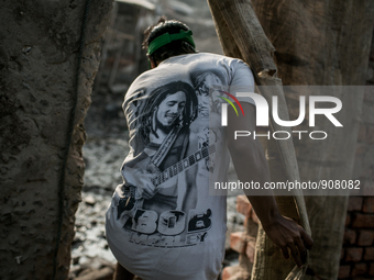 A man is going through a punch of the Boundary wall of waste dumping ground, Dhapa, Kolkata, India. January 20, 2015.  *** Go to http://nurp...