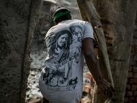 A man is going through a punch of the Boundary wall of waste dumping ground, Dhapa, Kolkata, India. January 20, 2015.  *** Go to http://nurp...