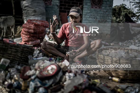 A man is sorting out the waste bottles collected from the dumping ground, Dhapa, Kolkata, India. January 20, 2015.  *** Go to http://nurphot...