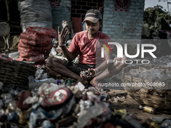 A man is sorting out the waste bottles collected from the dumping ground, Dhapa, Kolkata, India. January 20, 2015.  *** Go to http://nurphot...