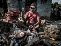 A man is sorting out the waste bottles collected from the dumping ground, Dhapa, Kolkata, India. January 20, 2015.  *** Go to http://nurphot...