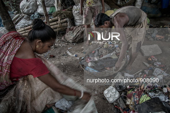 Workers are sorting out the wastes collected from the dumping ground. Dhapa, Kolkata, India. September 13, 2015.  *** Go to http://nurphoto....