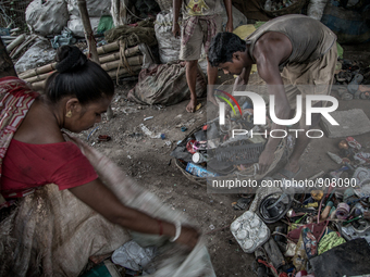 Workers are sorting out the wastes collected from the dumping ground. Dhapa, Kolkata, India. September 13, 2015.  *** Go to http://nurphoto....