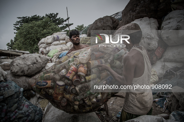 Workers are collecting the sorted waste bottles for sell. Dhapa, Kolkata, India. September 13, 2015.  *** Go to http://nurphoto.com/en/repor...