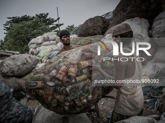 Workers are collecting the sorted waste bottles for sell. Dhapa, Kolkata, India. September 13, 2015.  *** Go to http://nurphoto.com/en/repor...