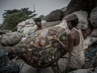 Workers are collecting the sorted waste bottles for sell. Dhapa, Kolkata, India. September 13, 2015.  *** Go to http://nurphoto.com/en/repor...