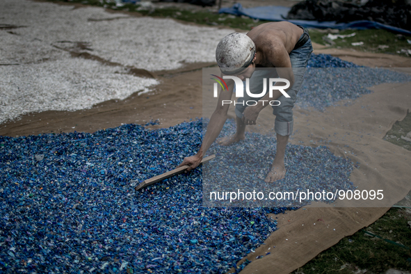 A man is sorting out the waste plastics at Dhapa, Kolkata, India. January 17, 2015.  *** Go to http://nurphoto.com/en/reportages/51754 to se...