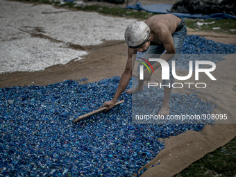 A man is sorting out the waste plastics at Dhapa, Kolkata, India. January 17, 2015.  *** Go to http://nurphoto.com/en/reportages/51754 to se...