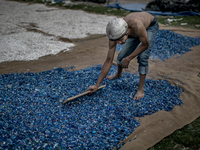 A man is sorting out the waste plastics at Dhapa, Kolkata, India. January 17, 2015.  *** Go to http://nurphoto.com/en/reportages/51754 to se...