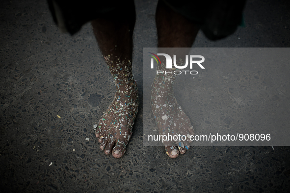 A worker who sorts out plastic in a plastic factory got his feet covered with plastics at Dhapa west dumping ground, Kolkata, India. January...