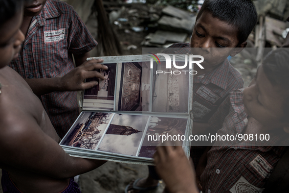 Kids found a photo album from the waste dumping ground, Dhapa, Kolkata, India. September 11, 2015.  *** Go to http://nurphoto.com/en/reporta...