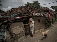 An old woman in front of her house at the village of Dhapa waste dumping ground. Dhapa, Kolkata, India. September 11, 2015.  *** Go to http:...