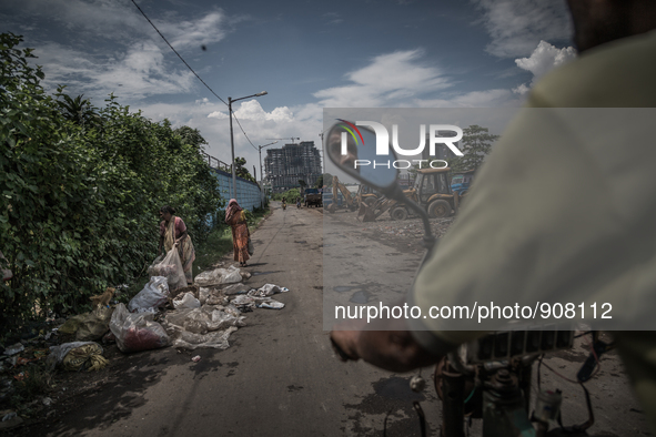 View of the city through the road of Dhapa waste dumping ground. Dhapa, Kolkata, India. September 14, 2015.  *** Go to http://nurphoto.com/e...