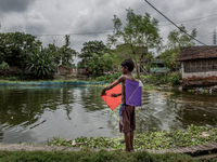 A kid is preparing his kites. Dhapa, Kolkata, India. September 11, 2015.  *** Go to http://nurphoto.com/en/reportages/51754 to see more ****...