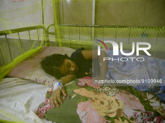 Bangladeshi child dengue patients covered with a mosquito net suffers from dengue fever as they receive treatment inside the Dhaka Child Hos...