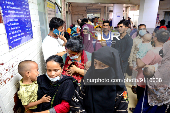 Relatives gather with their child patients in front of the emergency gate as they come to Dhaka child hospital for treatment in Dhaka, Bangl...