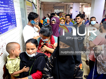 Relatives gather with their child patients in front of the emergency gate as they come to Dhaka child hospital for treatment in Dhaka, Bangl...