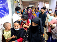 Relatives gather with their child patients in front of the emergency gate as they come to Dhaka child hospital for treatment in Dhaka, Bangl...