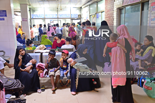 Relatives gather with their child patients in front of the emergency gate as they come to Dhaka child hospital for treatment in Dhaka, Bangl...