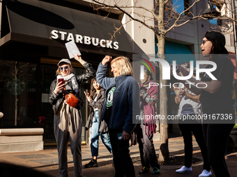 Employees and supporters cheer when the results of a unionization vote are anncounced at a store in Arlington, VA.  Employees, led by Samuel...