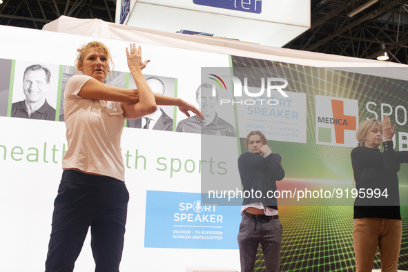 Heike Henkel, an Olympic champion, teaches exercise during the opening day of Medica 2022, a medical technology and health care exhibition i...