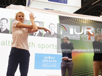 Heike Henkel, an Olympic champion, teaches exercise during the opening day of Medica 2022, a medical technology and health care exhibition i...