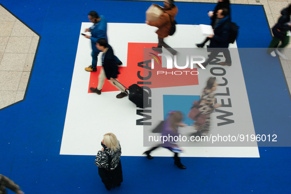 fairgoers are seen at the entrance during the opening day of Medica 2022, a medical technology and health care exhibition in Duesseldorf, Ge...