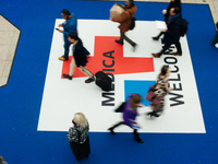 fairgoers are seen at the entrance during the opening day of Medica 2022, a medical technology and health care exhibition in Duesseldorf, Ge...