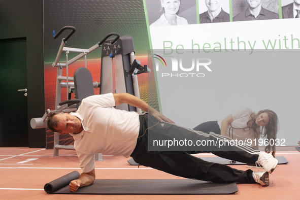 Lars Riedel, an Olympic champion, teaches exercise during the opening day of Medica 2022, a medical technology and health care exhibition in...