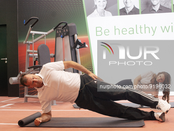 Lars Riedel, an Olympic champion, teaches exercise during the opening day of Medica 2022, a medical technology and health care exhibition in...